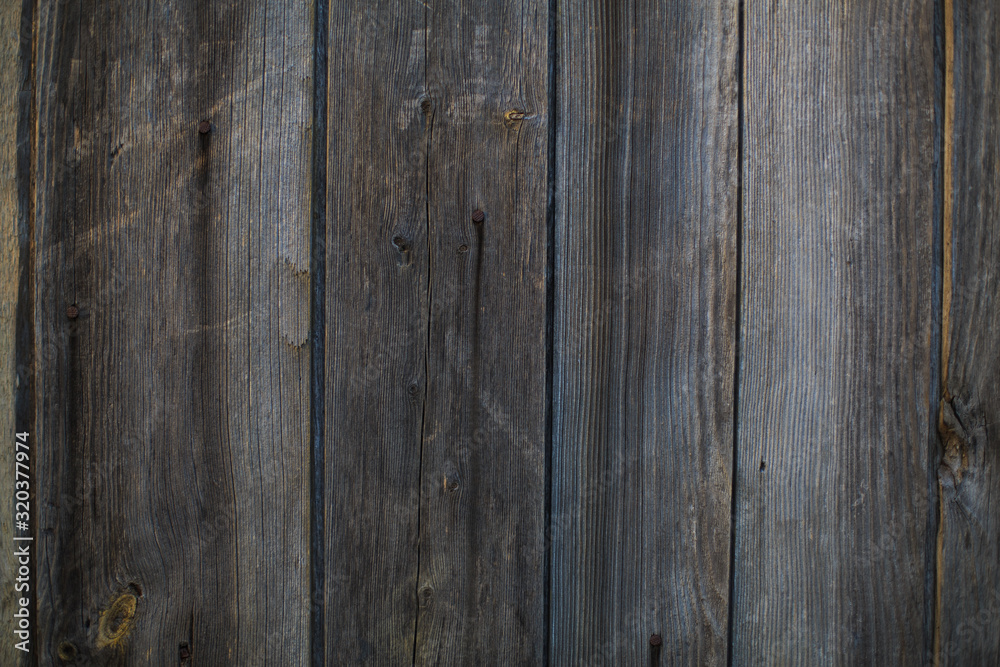 Old wooden door made of wooden boards with nails, retro wood texture Old wooden door made of wooden boards with nails, retro wood texture
