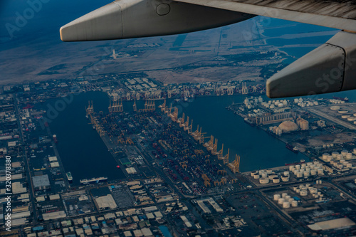 travel, in, Dubai, vacation, flight, on, plane, altitude, sky, view, in, porthole, wing, plane, sunrise, clouds, sun, rays, light, dawn, beauty, Persian, Gulf, water, buildings, land, port, cranes, pa