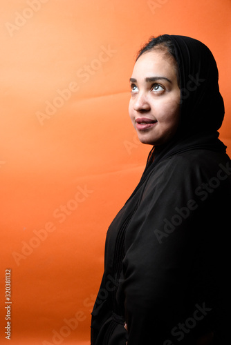 Portrait of arabic woman with traditional abaya dress in a studio