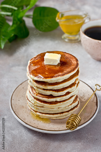 Healthy and delicious breakfast: coffee and stack of classic american pancakes with butter and honey