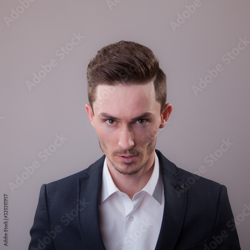 Handsome young elegant man studio portrait.