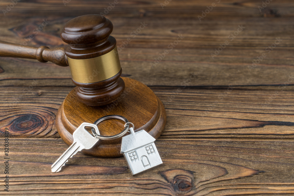 House keys and judge gavel. Concept purchase sale, rent, auction, mortgage. The arrest of property, the imposition of restrictions.