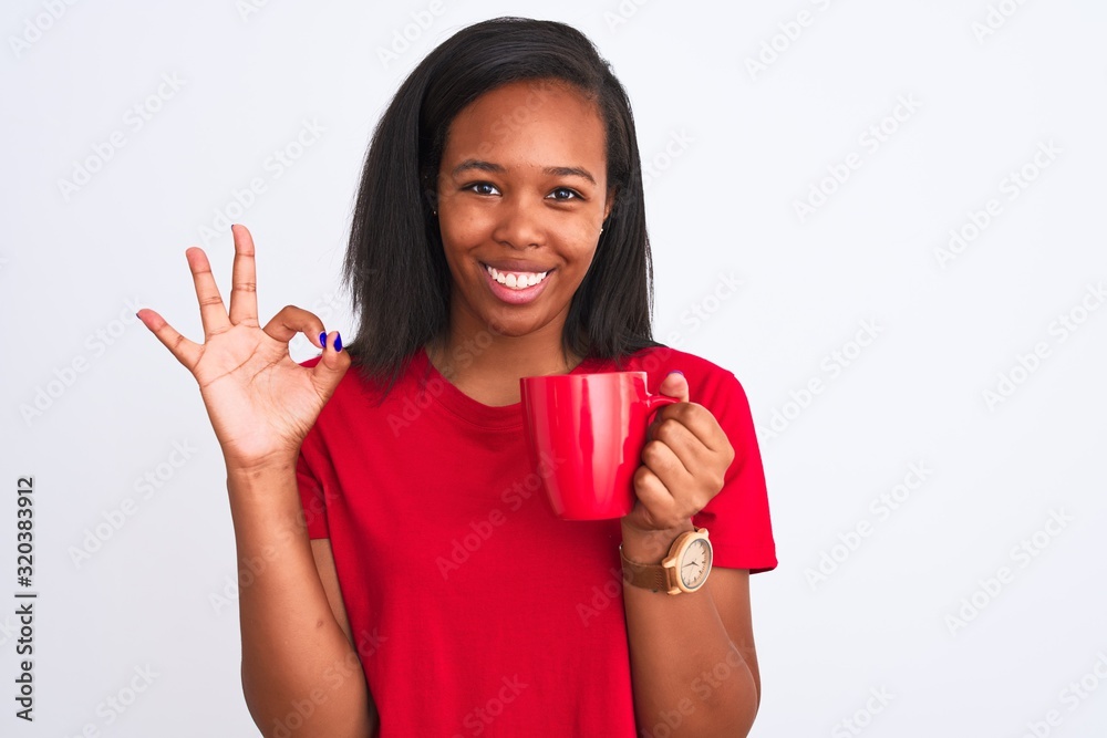 Young african american woman drinking a cup of coffee over isolated background doing ok sign with fingers, excellent symbol Young african american woman drinking a cup of coffee over isolated background doing ok sign with fingers, excellent symbol