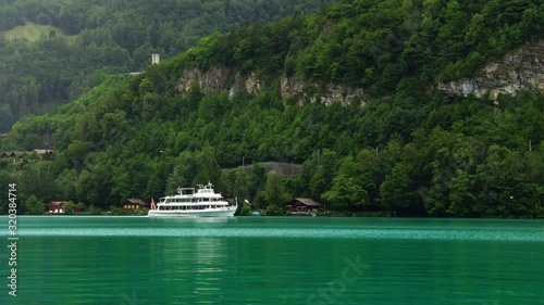 Wallpaper Mural Tourist boat ship on Lake Thun Brienz in Interlaken. Beautiful Swiss Alps nature in Switzerland, 4k. Summer tourism destination. Turquoise blue lake water.  Torontodigital.ca