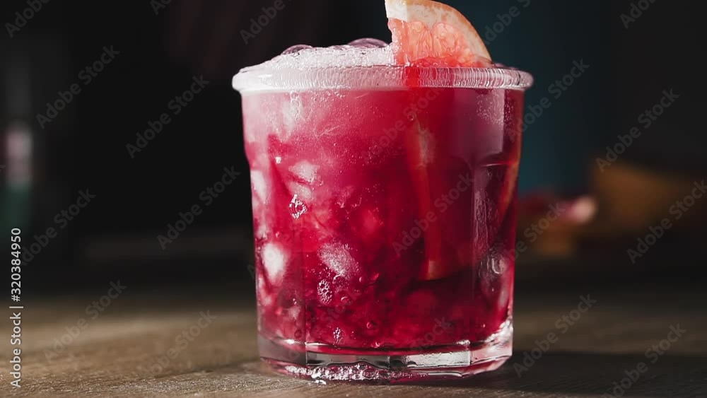 Bartender is preparing cocktail with grapefruit, mint and ice, slow motion. Grapefruit cocktail, close up.
