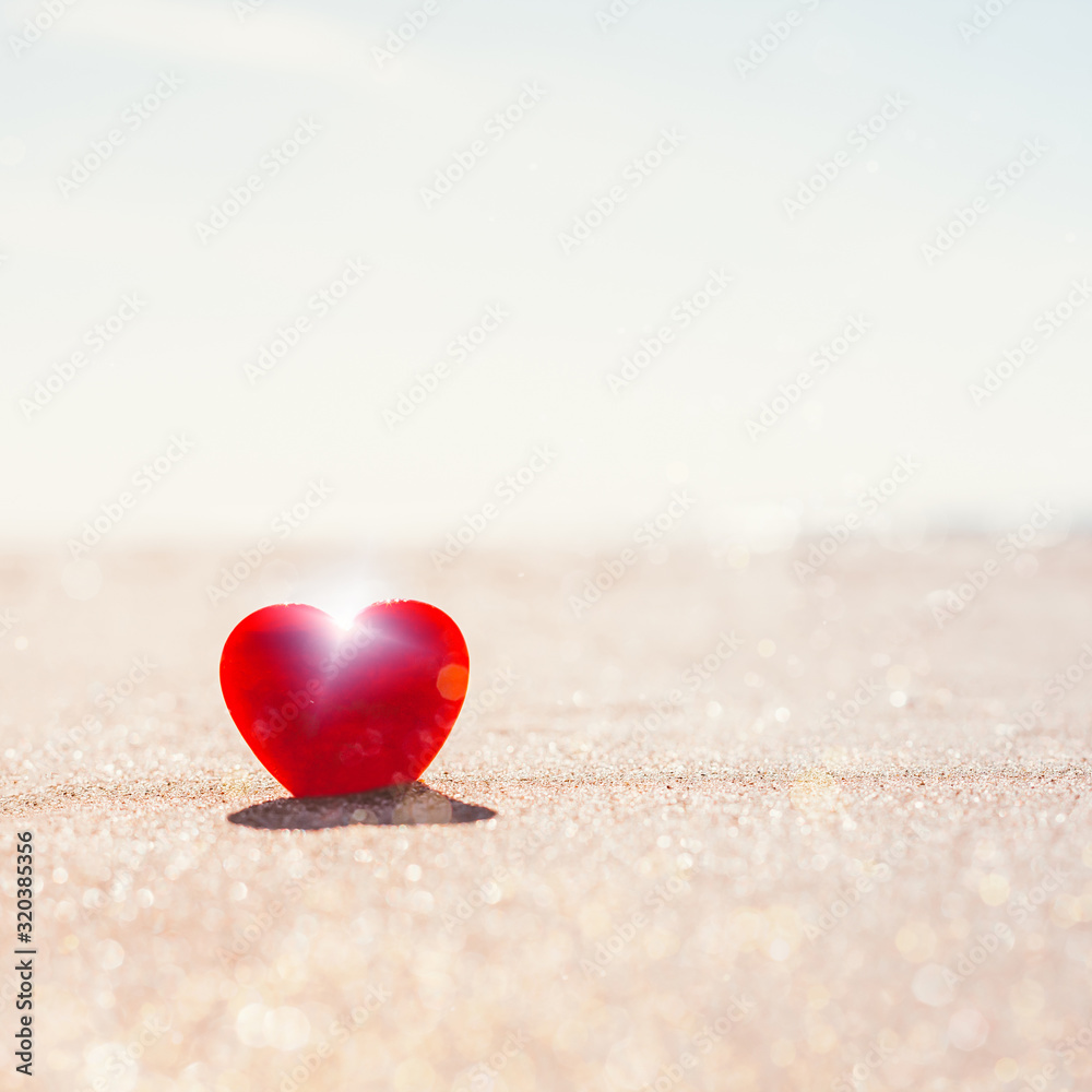 Romantic symbol of red heart on the sand beach Romantic symbol of red heart on the sand beach