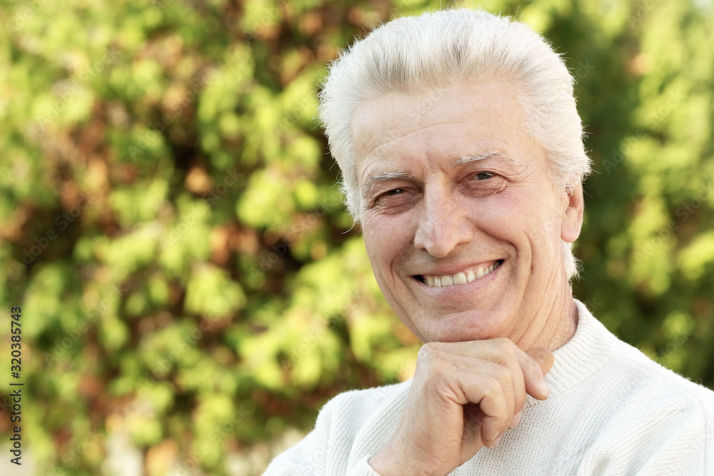 Portrait of happy senior man in park Portrait of happy senior man in park
