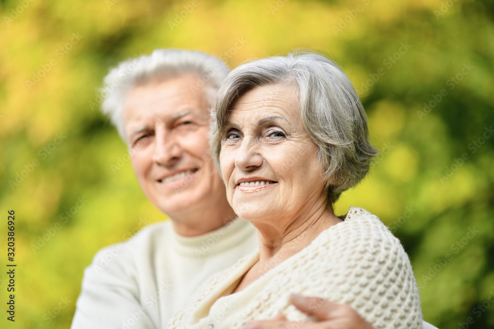 Beautiful senior couple posing in the park Beautiful senior couple posing in the park