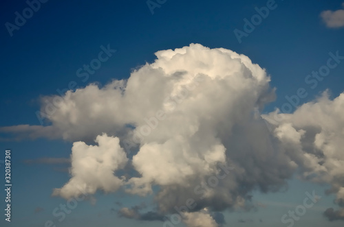 Blue sky with big white and grey clouds.