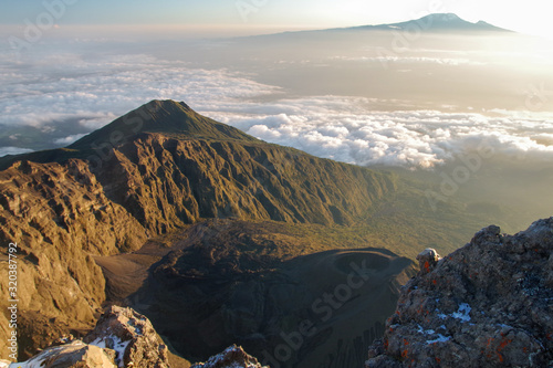 Mount Meru and its ash cone above clouds. Arusha  Tanzania. Africa.  photo