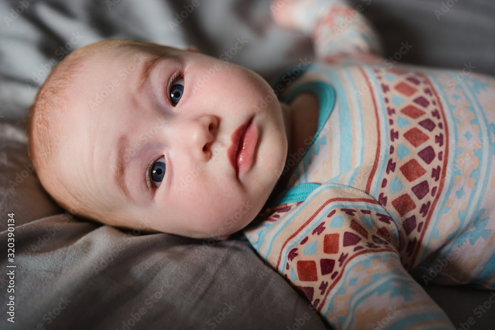 Cute young boy laying on the bed