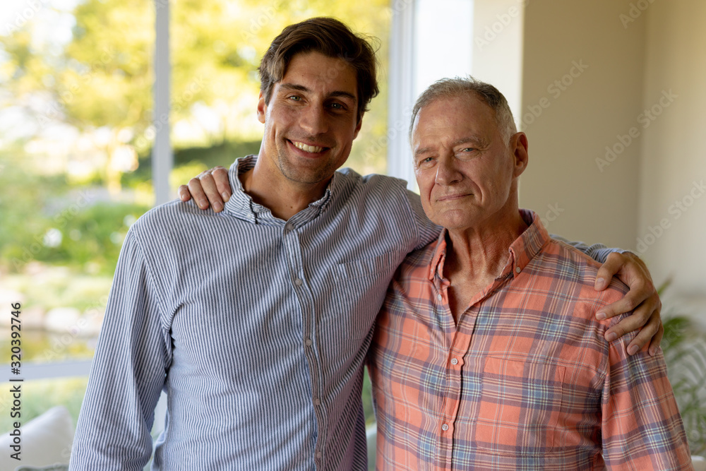 Fototapeta premium Father and son holding each other at home