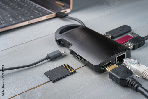 Obraz na płótnie USB Type C adapter or hub with various accessories - pendrives, hdmi, ethernet, memory card, cables. w salonie