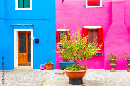 Pink and blue painted facades of the houses. Colorful architecture in Burano island, Venice, Italy.