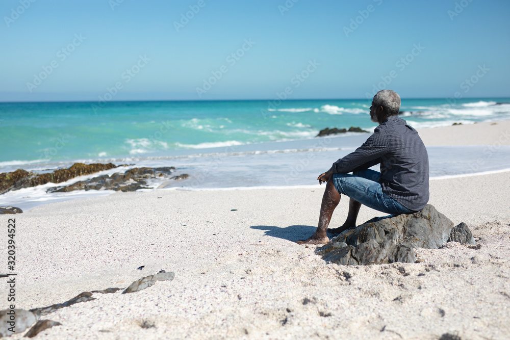 Old man looking at the waves