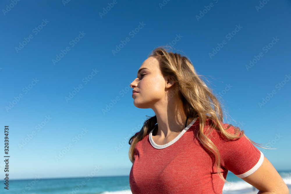 Side view of young woman at the beach