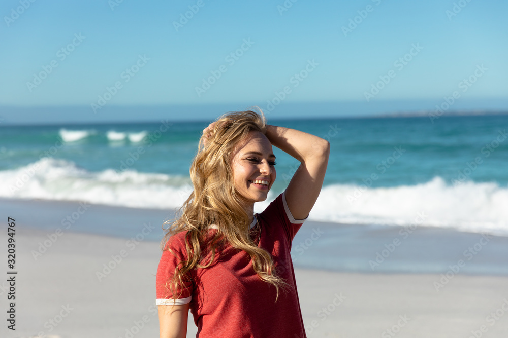 Young woman smiling at the beach Young woman smiling at the beach