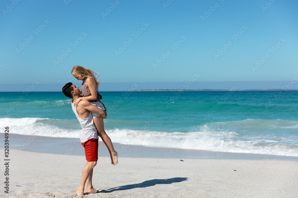 Boyfriend carrying girlfriend at the beach Boyfriend carrying girlfriend at the beach