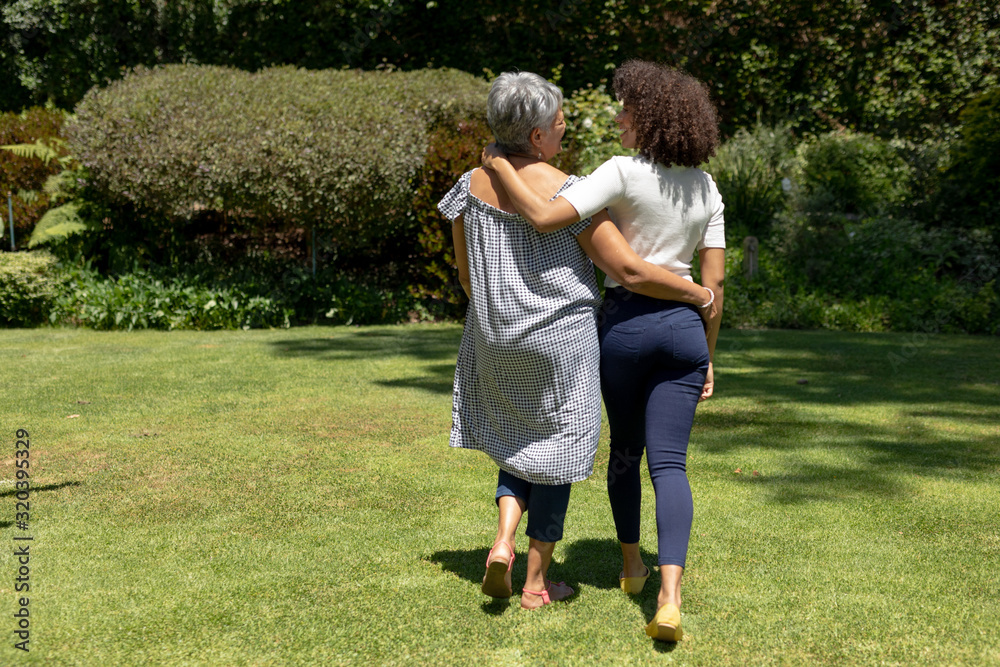Two women walking in the garden Two women walking in the garden