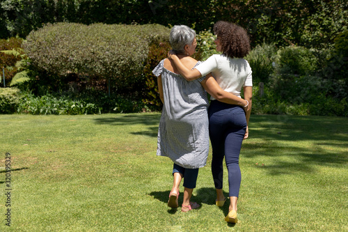 Two women walking in the garden