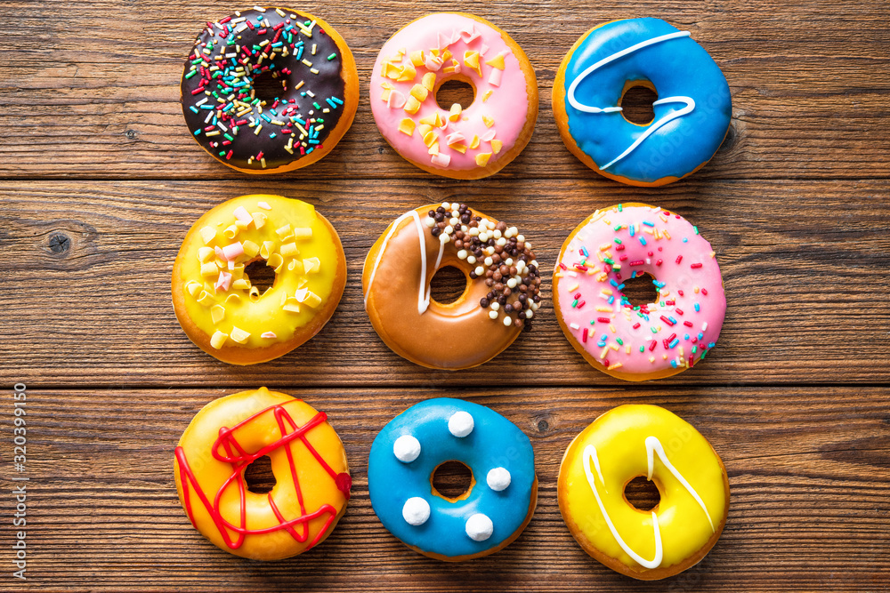 Various colorful donuts on wooden Various colorful donuts on wooden