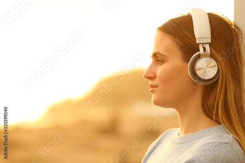 Profile of a woman with headphones listening to music