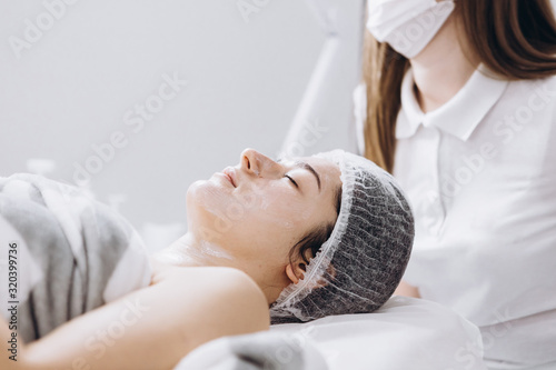 01.02.2020 Kyiv, Ukraine: Dermatologist working in a beauty salon and engaged in beauty injections and facial peels for clients. Spa, beauty and self care concept