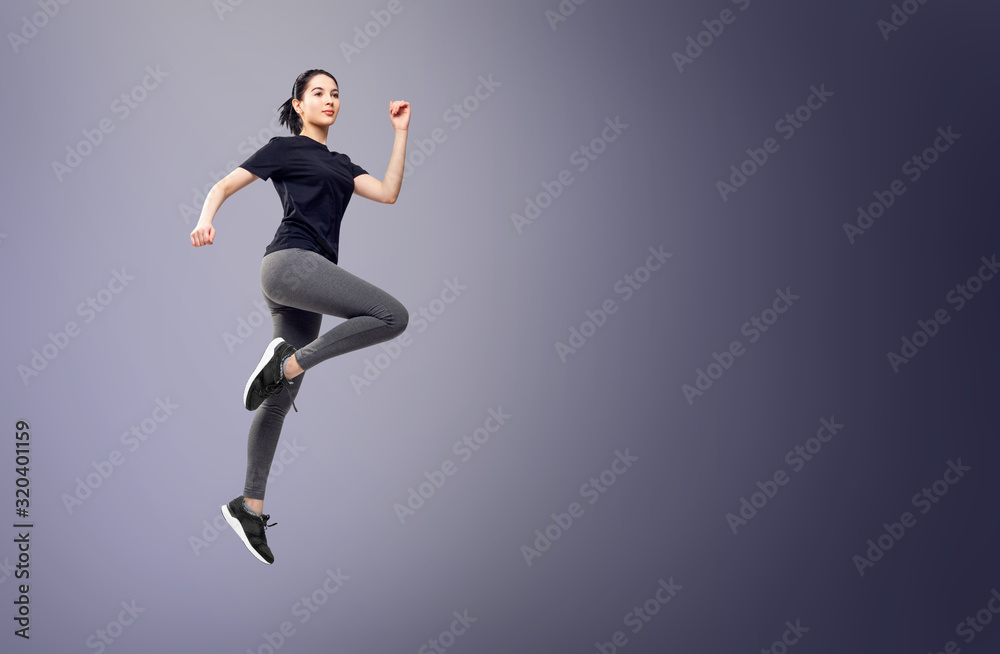 Full length portrait of fitness woman in sportswear jumping.