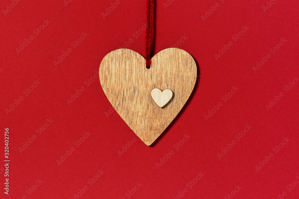 Wooden heart on the red background, composition for Valentines day Wooden heart on the red background, composition for Valentines day