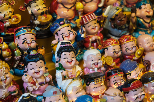 Happy smiling, asian toy figures, Chinese miniature puppets