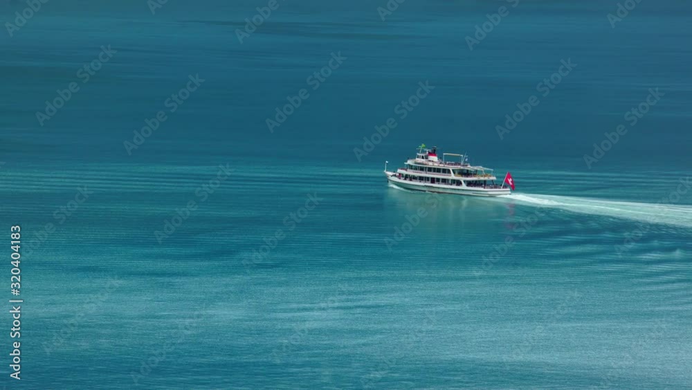 Tourist boat ship on Lake Thun Brienz in Interlaken. Beautiful Swiss Alps nature in Switzerland, 4k. Summer tourism destination. Turquoise blue lake water. Tourist boat ship on Lake Thun Brienz in Interlaken. Beautiful Swiss Alps nature in Switzerland, 4k. Summer tourism destination. Turquoise blue lake water.
