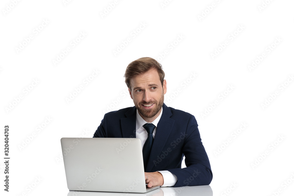 happy young man in navy blue suit looking to side and wondering happy young man in navy blue suit looking to side and wondering