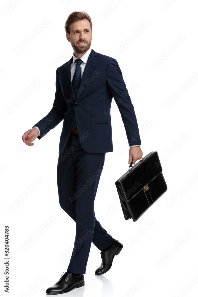 confident businessman in navy blue suit holding suitcase confident businessman in navy blue suit holding suitcase
