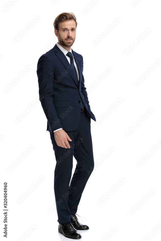 young businessman in navy blue suit holding hands in pocket young businessman in navy blue suit holding hands in pocket