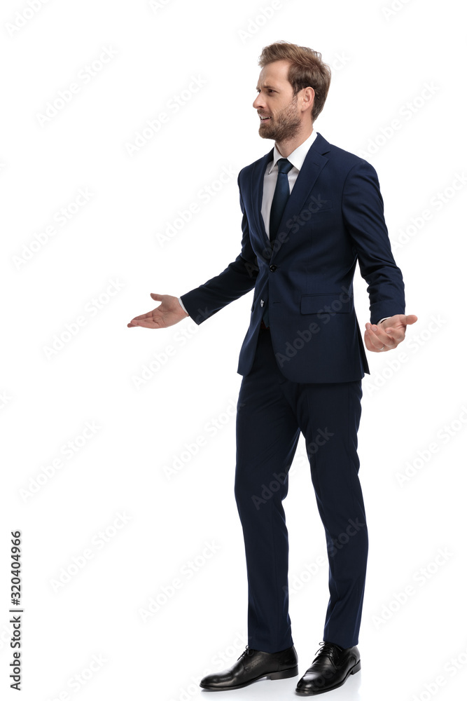 young businessman in navy blue suit asking for explanations young businessman in navy blue suit asking for explanations