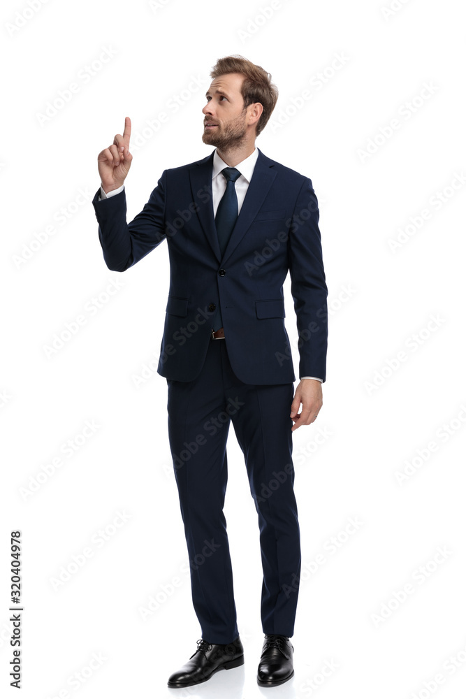 confused businessman looking up side and poining finger confused businessman looking up side and poining finger