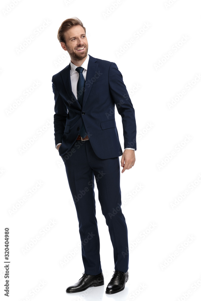 happy businessman in navy blue suit smiling and looking to side happy businessman in navy blue suit smiling and looking to side