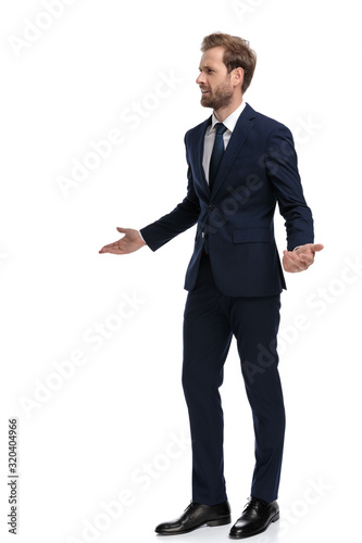 Bild auf Leinwand young businessman in navy blue suit asking for explanations