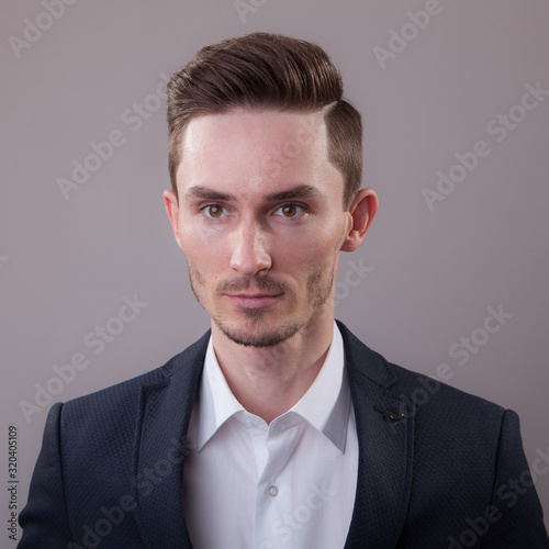 Handsome young elegant man studio portrait.