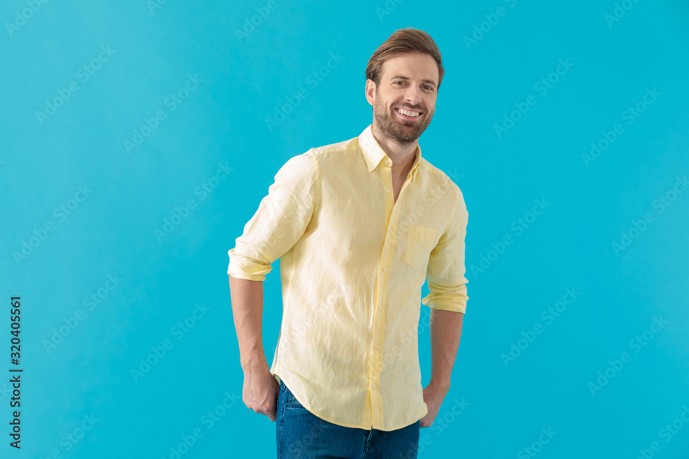 Happy casual holding laughing with both hands in his pockets Happy casual holding laughing with both hands in his pockets