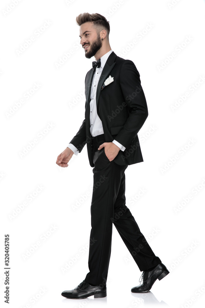 businessman walking with one hand in pocket on his way businessman walking with one hand in pocket on his way