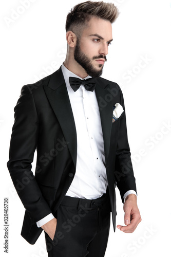 businessman standing with hand in pocket and looking away cool