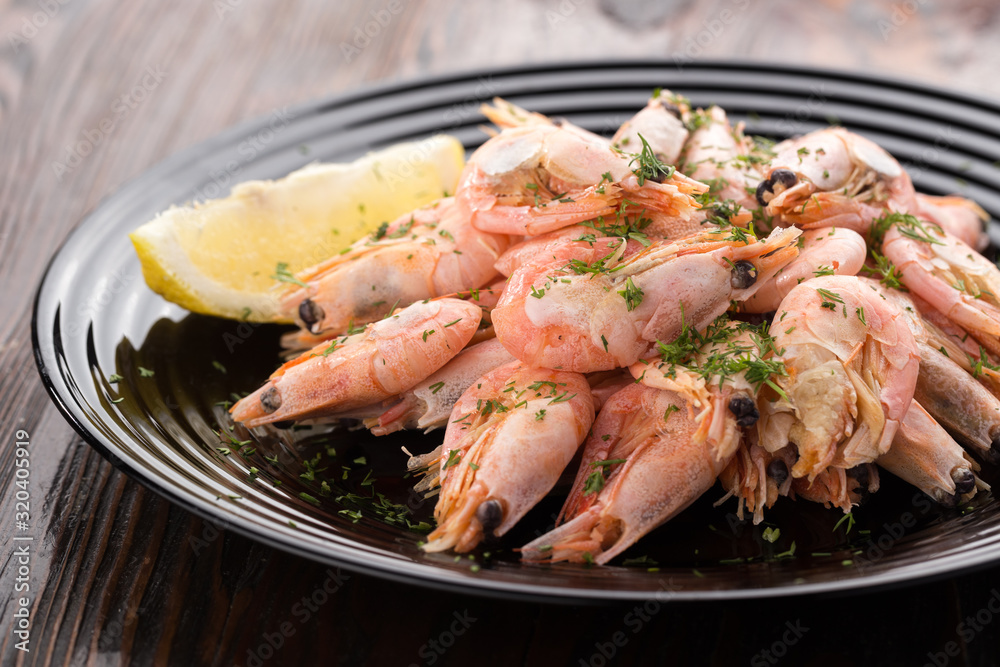 Shrimp on a plate Seafood, shelfish. Shrimps with herbs, garlic and lemon. Sea Food.
