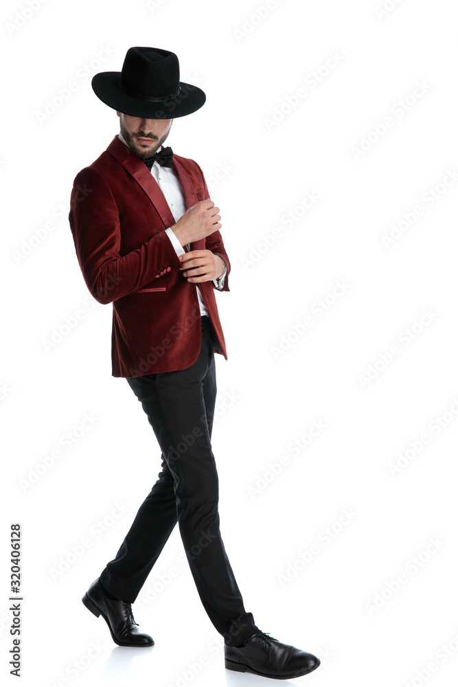 mysterious young model in red velvet tuxedo walking
