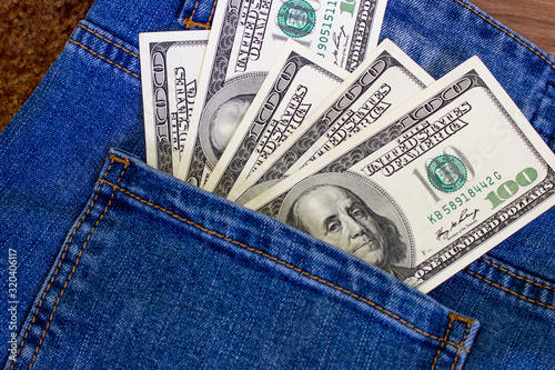 Money in the pocket of jeans. United States dollars