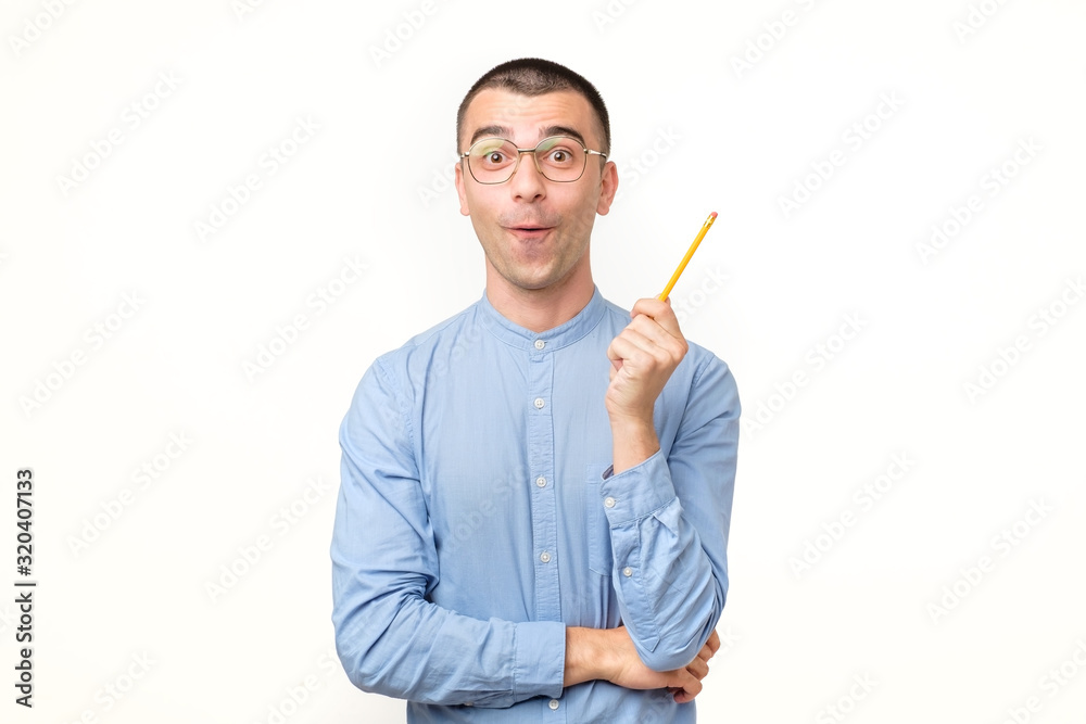 Young hispanic man in glasses is thinking about something with pencil Young hispanic man in glasses is thinking about something with pencil