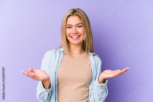 Young blonde caucasian woman isolated showing a welcome expression.