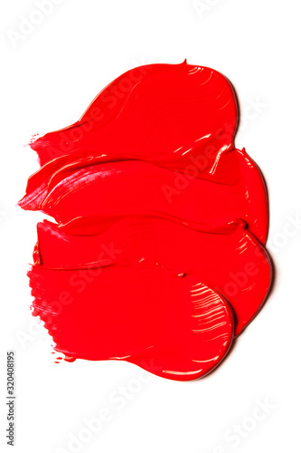 Texture of classic red lipstick on a white background close-up.