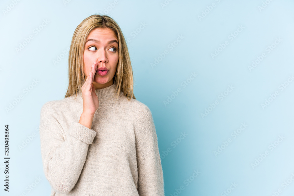 Young blonde caucasian woman isolated is saying a secret hot braking news and looking aside Young blonde caucasian woman isolated is saying a secret hot braking news and looking aside