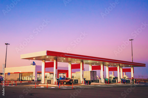 modern car gas station with cars on the background of a beautiful sunset or dawn © serhio777